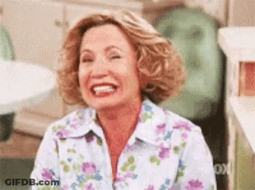 Woman In Floral Shirt Laughing With Eyes Closed GIF