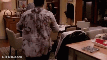 Woman In Floral Shirt Looking At Table GIF