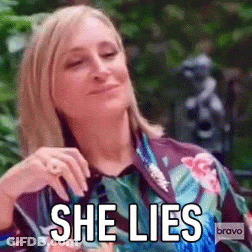 Woman In Floral Shirt Making Funny Face Saying She Lies GIF