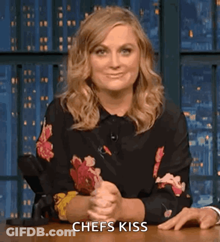 Woman In Floral Shirt Saying Chefs Kiss GIF