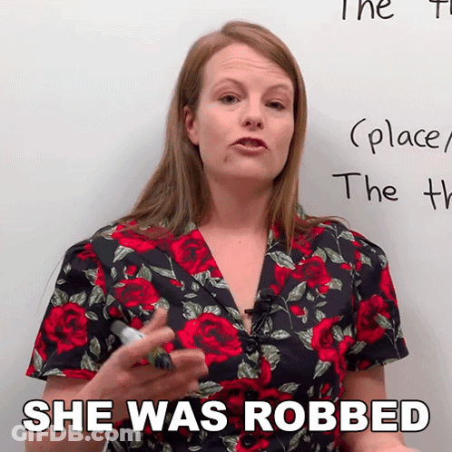 Woman In Floral Shirt Says She Was Robbed In Front Of Whiteboard GIF