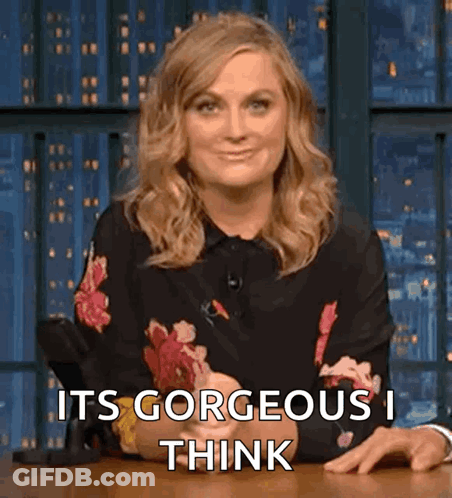 Woman In Floral Shirt Sitting At Table GIF