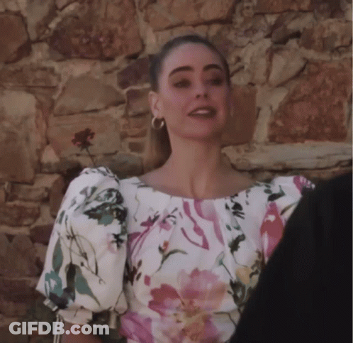 Woman In Floral Top With Puffed Sleeves GIF