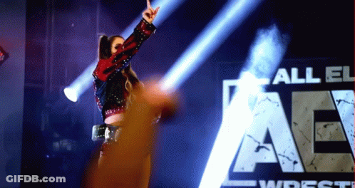 Woman In Front Of All Elite Wrestling Sign GIF