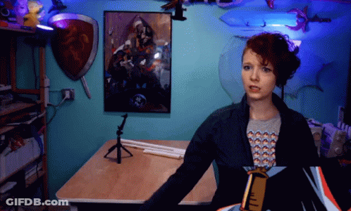 Woman In Front Of Blue Wall With Painting GIF