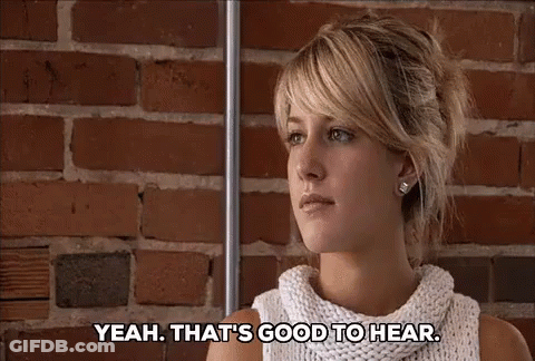 Woman In Front Of Brick Wall Saying Yeah That's Good To Hear GIF