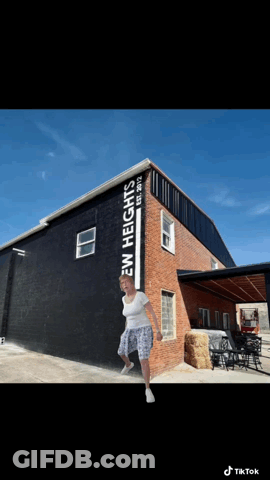 Woman In Front Of Building Saying Ew Heights GIF