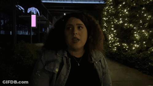 Woman In Front Of Building Saying Move GIF