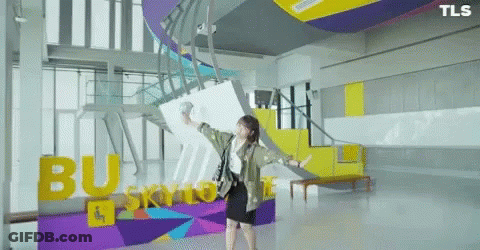 Woman In Front Of Busy Skyline Sign GIF