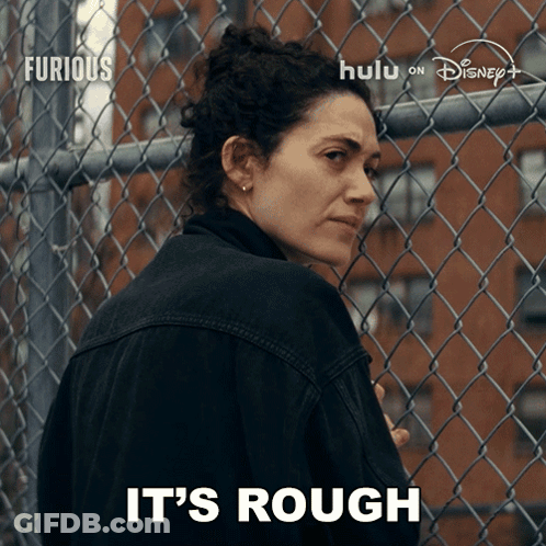 Woman In Front Of Chain Link Fence Saying It's Rough On The Bottom GIF