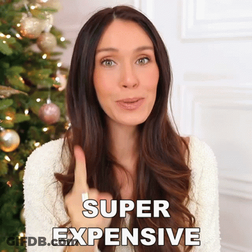 Woman In Front Of Christmas Tree Saying Super Expensive GIF