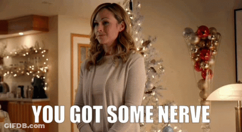 Woman In Front Of Christmas Tree Saying You Got Some Nerve GIF