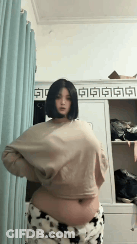 Woman In Front Of Closet With Chinese Characters GIF