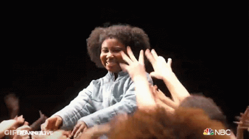 Woman In Front Of Crowd With NBC Logo GIF