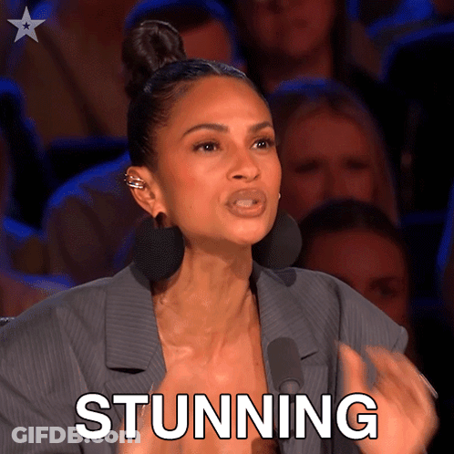 Woman In Front Of Crowd With Stunning On Face GIF