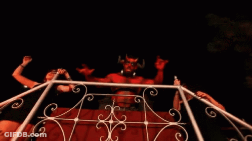 Woman In Front Of Devil Statue With Horns GIF