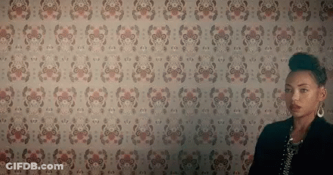 Woman In Front Of Floral Wall GIF