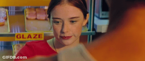 Woman In Front Of Glaze Sign GIF