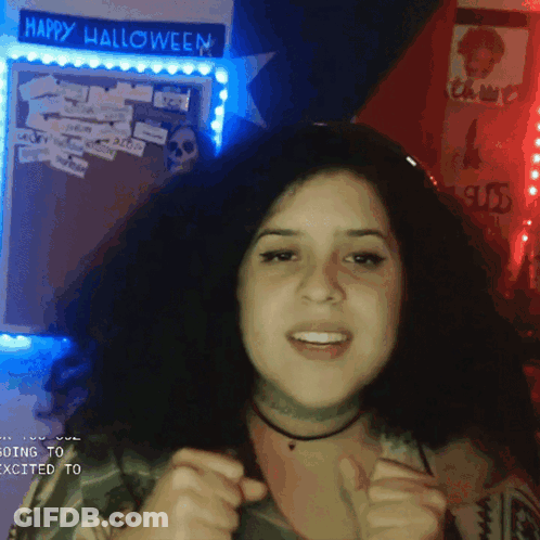 Woman In Front Of Happy Halloween Sign GIF