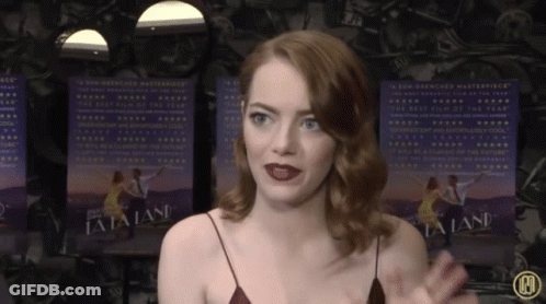 Woman In Front Of La La Land Posters GIF