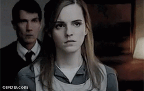 Woman In Front Of Man In Suit And Tie GIF