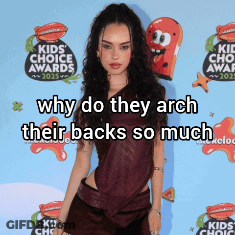 Woman In Front Of Nickelodeon Sign Says Why Do They Arch Their Backs GIF