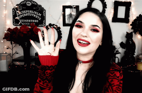 Woman In Front Of Ouija Board With Letters GIF