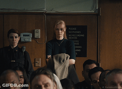 Woman In Front Of Please No Phones Sign GIF