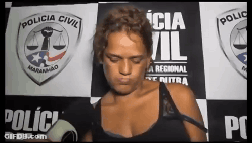 Woman In Front Of Policia Civil Wall GIF