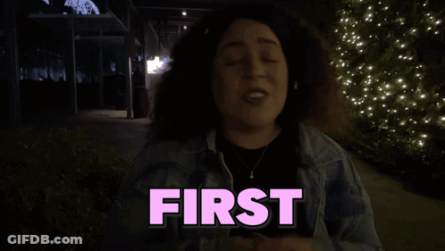 Woman In Front Of Sign Reading First GIF