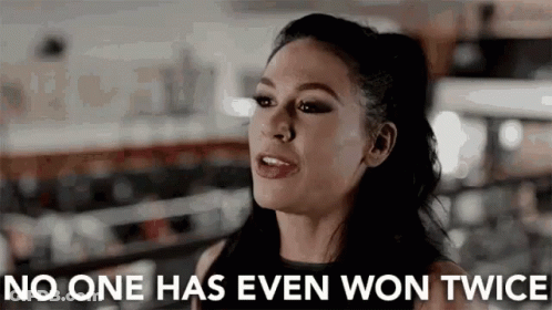 Woman In Front Of Sign Saying No One Has Ever Won Twice GIF