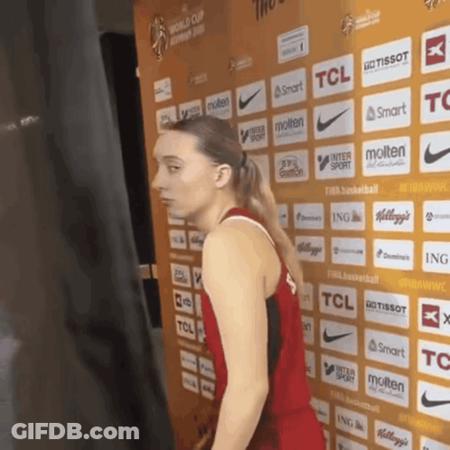 Woman In Front Of TCL And Molten Wall GIF