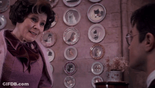 Woman In Front Of Wall Of Plates GIF