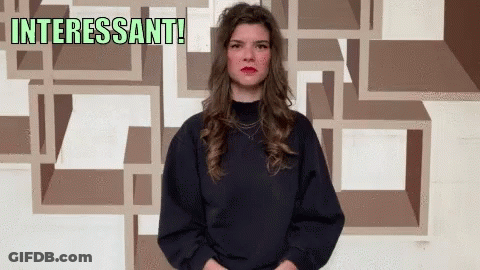 Woman In Front Of Wall Saying Interesting GIF