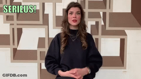 Woman In Front Of Wall Saying Serieus GIF