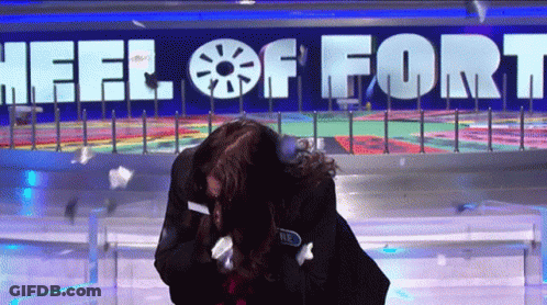 Woman In Front Of Wheel Of Fort Sign GIF
