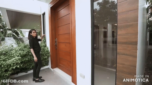 Woman In Front Of Wooden Door GIF
