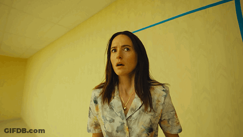 Woman In Front Of Yellow Wall GIF