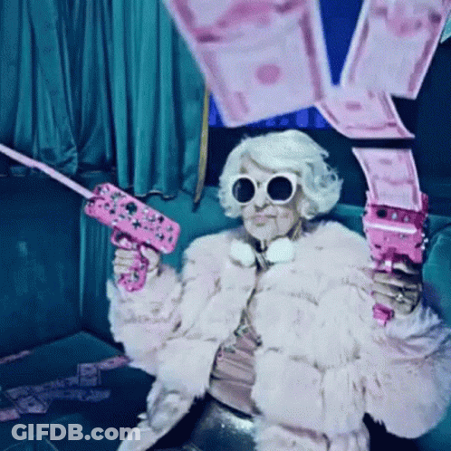 Woman In Fur Coat And Sunglasses Holding Pink Gun GIF