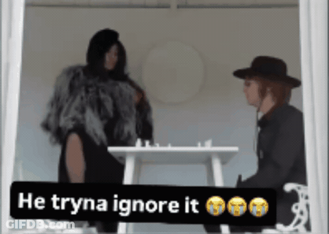 Woman In Fur Coat Next To Man In Black Hat Saying He Tryna Ignore It GIF