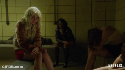 Woman In Fur Coat Sitting On Bathtub GIF