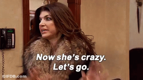 Woman In Fur Coat Standing In Front Of Telephone GIF