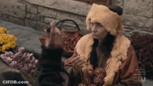 Woman In Fur Hat And Coat Talking To Another GIF