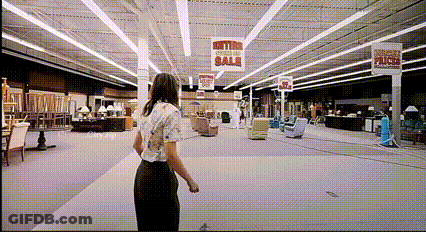 Woman In Furniture Store With Metro Section Sale Sign GIF