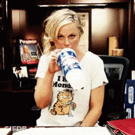 Woman In Garfield T-Shirt Drinking From Cup GIF