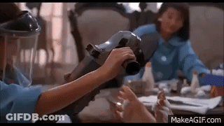 Woman In Gas Mask Holding Vacuum Cleaner GIF