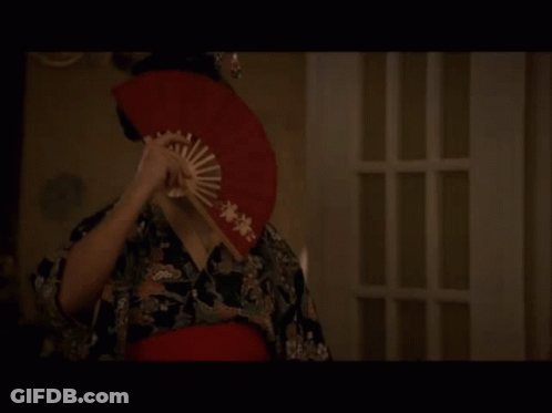 Woman In Geisha Costume Holding Red Fan GIF