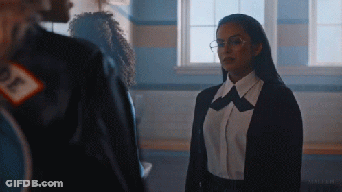 Woman In Glasses And Black Jacket Standing By Window GIF