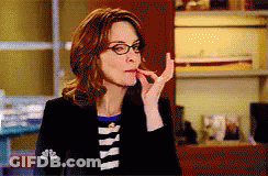 Woman In Glasses And Black Jacket With NBC On Sleeve GIF
