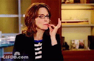 Woman In Glasses And Black Jacket With NBC Sleeve GIF